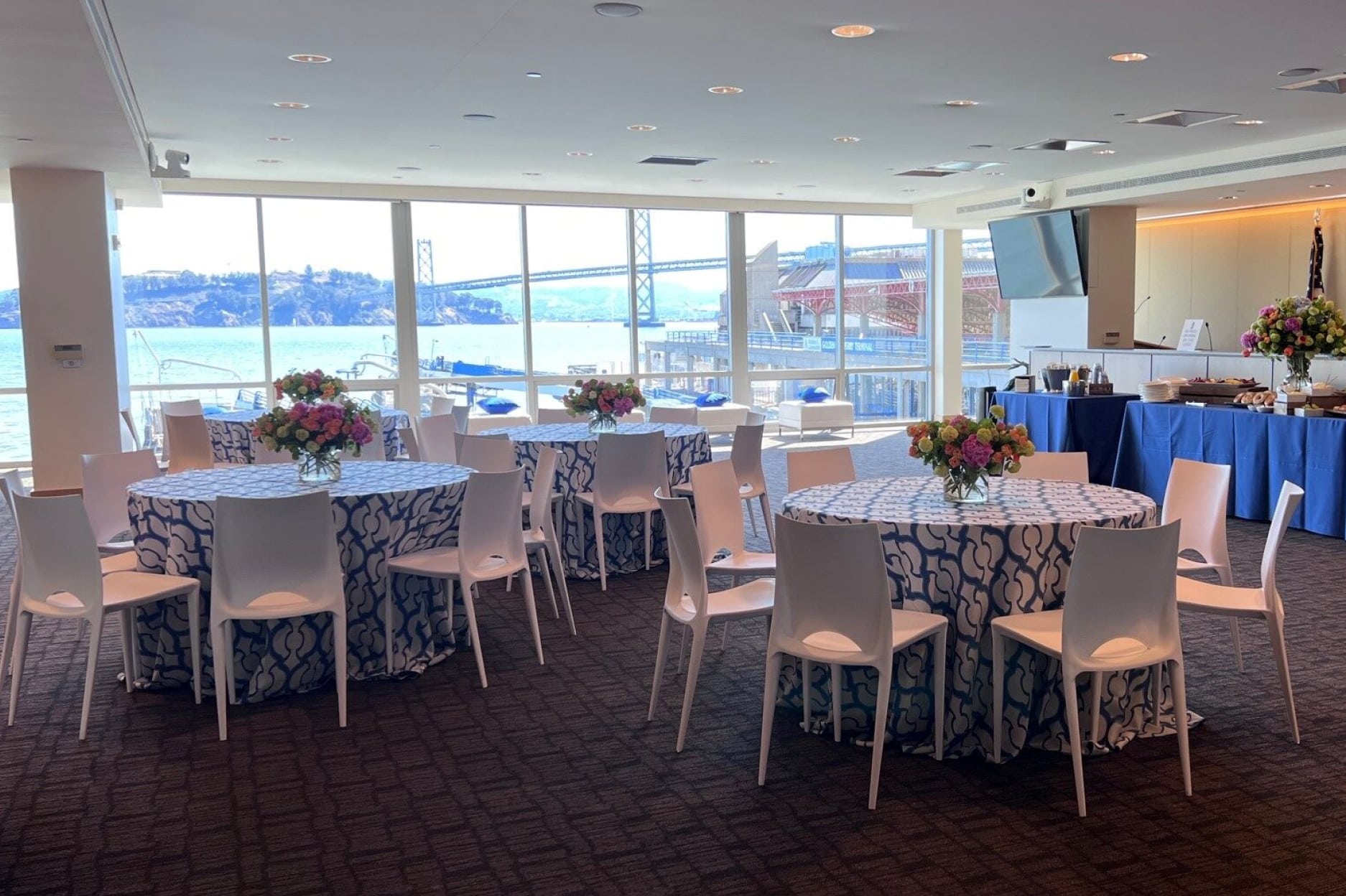 Spacious room with tables and chairs.