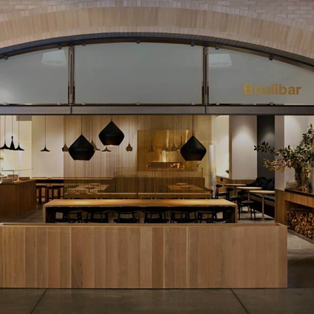 Boulibar restaurant interior with rustic wooden tables.