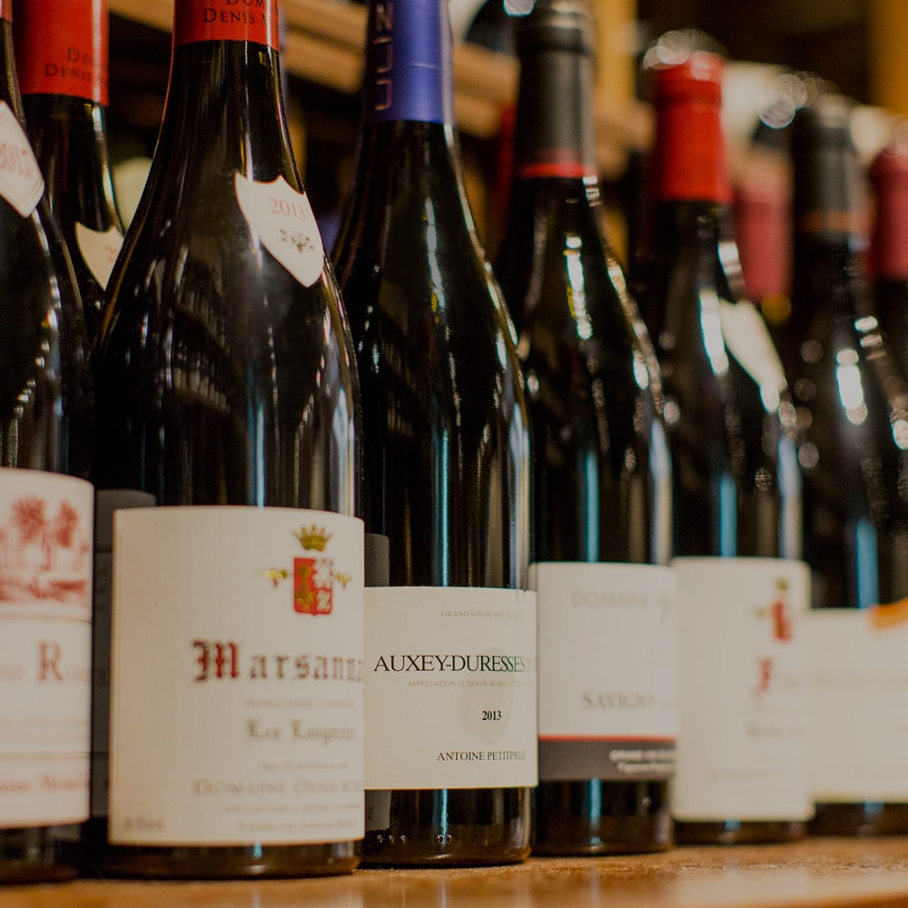 Well-stocked wine cellar with wine bottles.